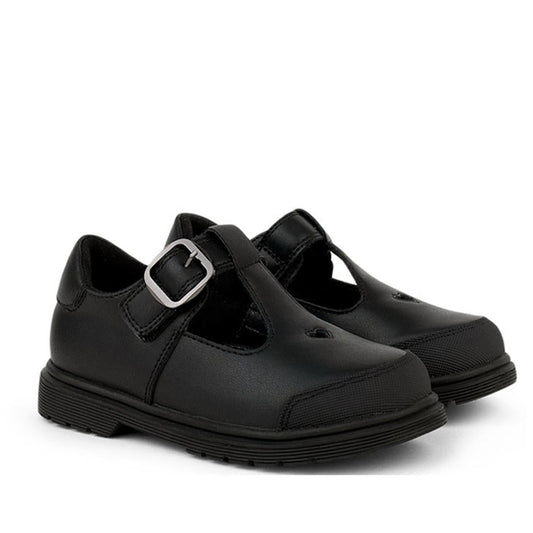 A pair of Pretty Brave Athena Trainer Black Leather T-Bar School Shoes with silver buckle and thick rubber soles, made from genuine leather, displayed on a white background.