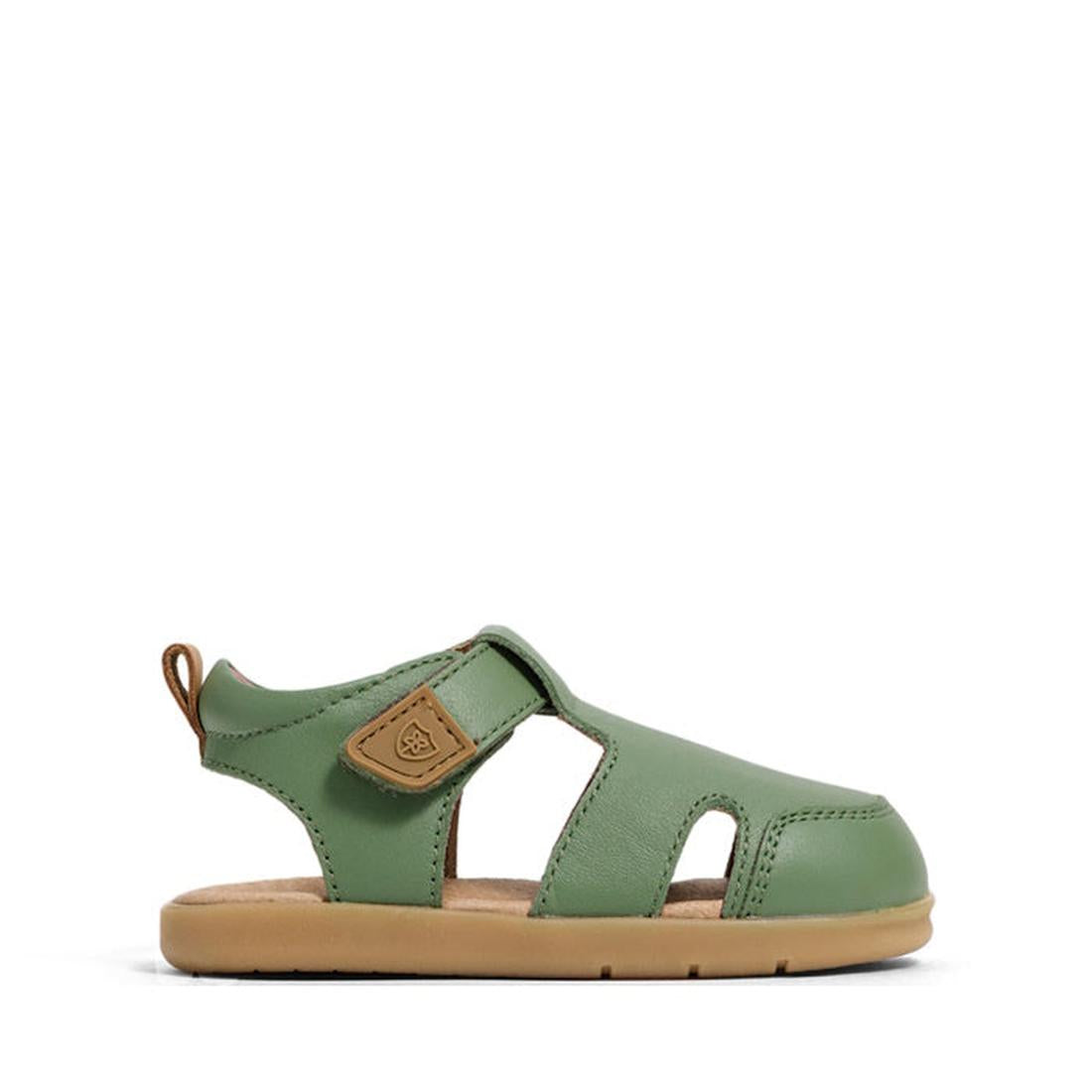 The Pretty Brave 1st Walker Eli Grass Leather Closed Toe Sandal is a green children’s sandal with cut-out sides, tan sole, adjustable Velcro strap, and a small tan pull tab at the heel., 9420075358669, 9420075358652, 9420075358645, 9420075358638