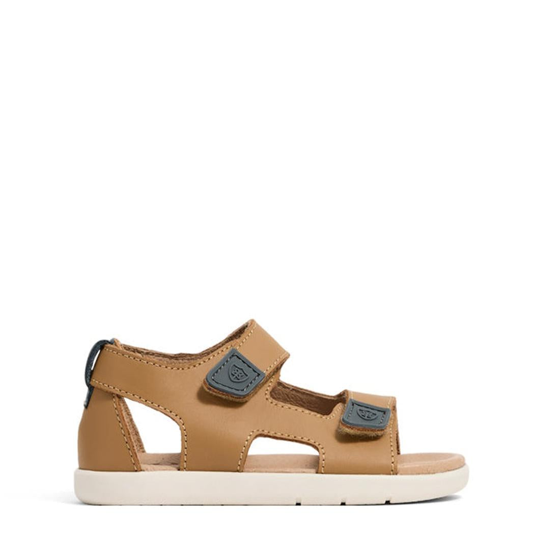 The Pretty Brave 1st Walker Jack Tan Leather Open Toe Sandal is a kids' summer shoe with two black Velcro straps, cut-out sides, a white sole, and low heel. Adjustable and comfortable, it's shown against a plain white background., 9420075358713, 942007535