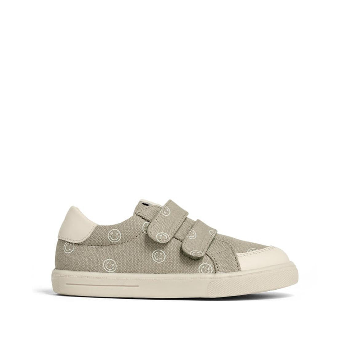 The Pretty Brave Otto Organic Canvas Trainer features a khaki smiley design, leather toe buffer, two velcro straps, white rubber sole, and white heel accent, shown in side profile on a plain background., 40216, 40217, 9420075333949, 9420075333932, 9420075