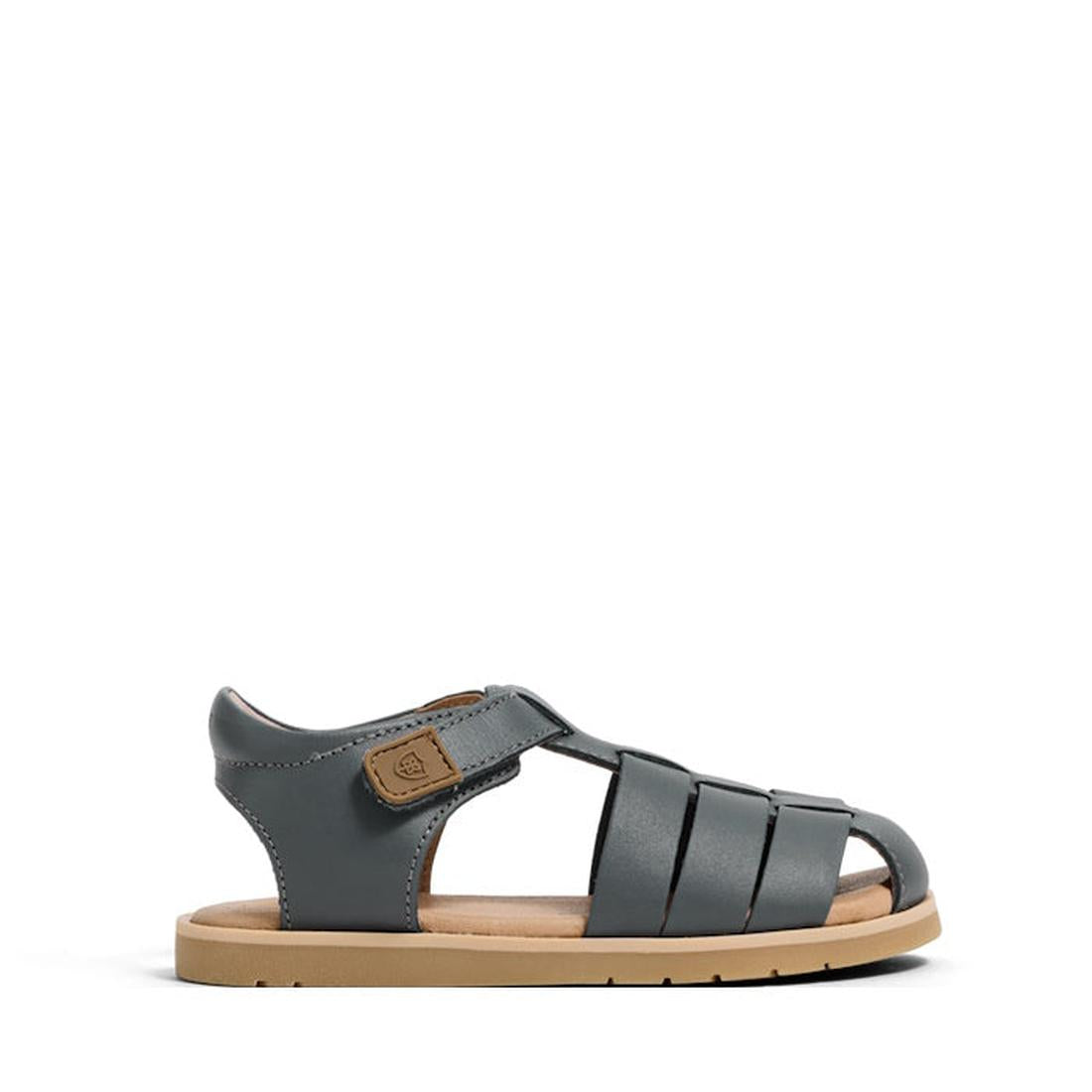 The Pretty Brave Child Rocco Indigo Leather Closed Toe Sandal features a velcro strap and tan sole, designed for children, and is shown on a white background., 9420075357556, 9420075357549, 9420075357532, 9420075357525, 9420075357518, 9420075357501, 94200