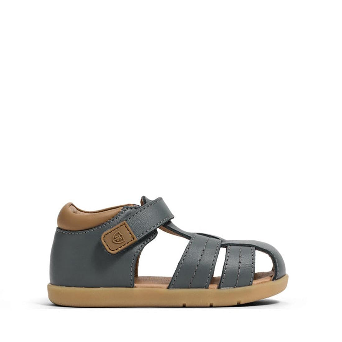 The Pretty Brave 1st Walker Theo indigo leather sandal is a supportive, closed-toe toddler sandal with tan accents, open sides, Velcro strap, light brown sole, podiatrist-approved design, and stylish visible stitching., 9420075358768, 9420075358751, 94200