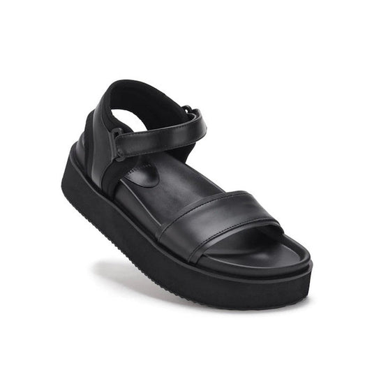 The Rollie Womens Ace Sandal All Black Leather is a lightweight platform sandal with a thick sole, open toe, two wide straps, and an ankle strap with hook-and-loop closure—perfect for comfortable all-day summer wear.