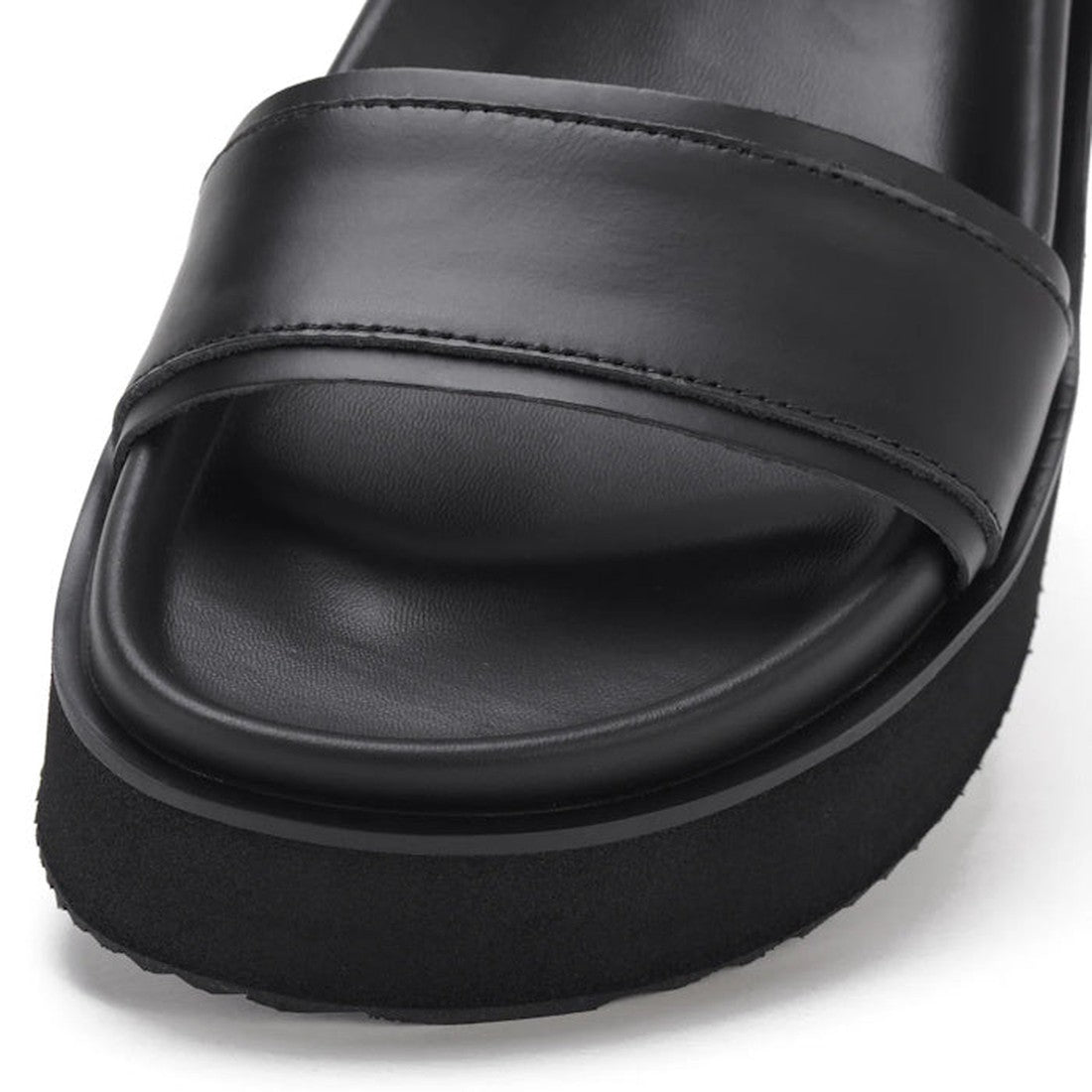 Close-up of the Rollie Womens Ace Sandal All Black Leather, featuring a wide premium leather strap, cushioned footbed, visible stitching details, and thick textured sole—ideal as a lightweight and comfortable summer platform sandal., 9339554333878, 933955