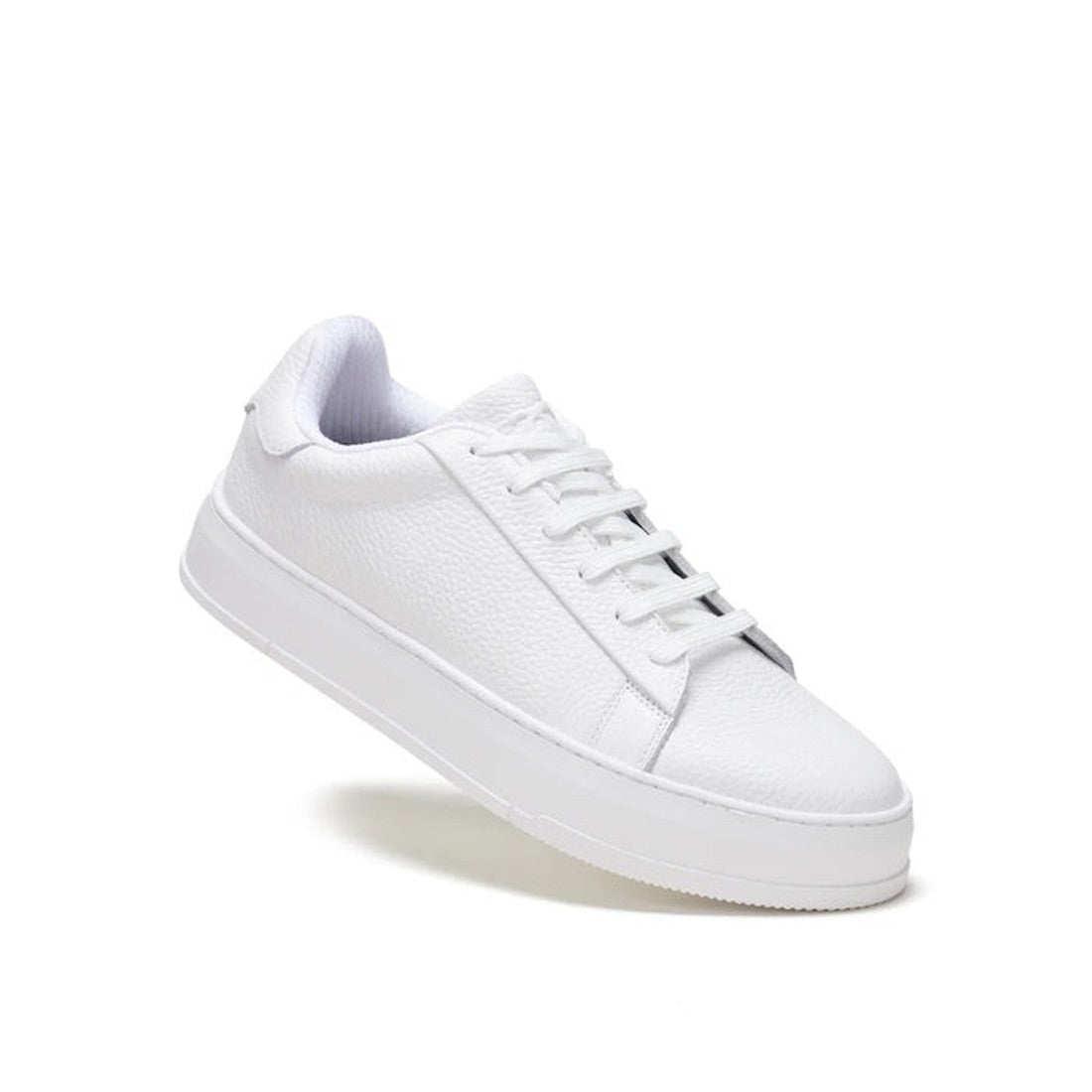 The Rollies Womens Court Club All White Leather Trainer is a low-top sneaker featuring textured premium leather, white laces, and an anti-slip rubber outsole, shown angled on a white background.