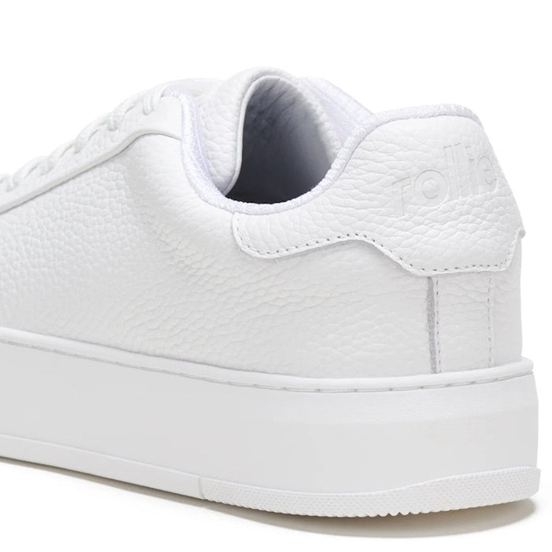 Close-up view of the back and side of the Rollies Womens Court Club All White Leather Trainer, featuring a textured white design, thick anti-slip rubber outsole, embossed brand name on the heel tab, and visible laces on the upper left., 9781760768737, 978