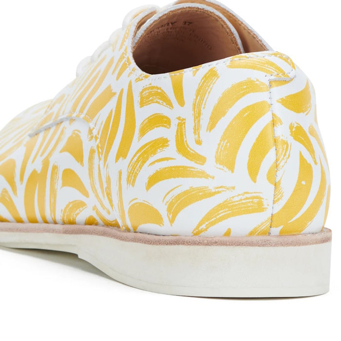 Close-up of the Rollie Womens Derby Sunshine Splash Leather Shoe, featuring a white premium leather upper with yellow abstract brushstroke pattern, a white rubber sole, and combining classic Derby style with modern sneaker-like comfort., 9781760774783, 97