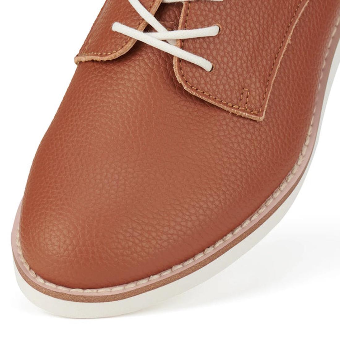 Close up view of Brown Cognac Rollie Derby showing pebbled look to the Brown recycled leather shoe with white laces on a white background.,
9781760789831,
9781760789848,
9781760789855,
9781760789862,
9781760789879,
9781760789886,, 9781760789831, 978176078