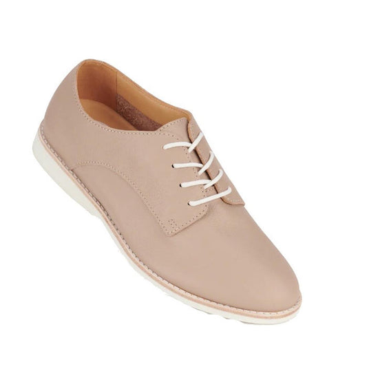The Rollie Womens Derby Super Soft Clay Leather Shoe is a beige Australian-designed lace-up with white laces and a white sole, shown on a plain white background.