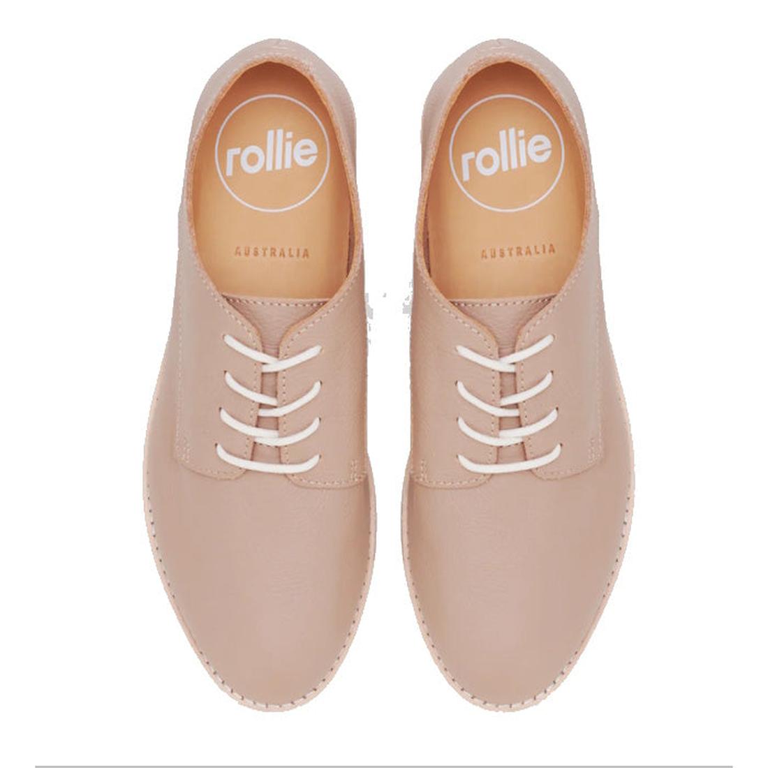 A top view of the Rollie Womens Derby Super Soft Clay Leather Shoe in beige shows white laces and "rollie AUSTRALIA" insoles. The Australian design features soft leather, a minimalist look, rounded toes, and is orthotic-friendly., 9781760781552, 978176078