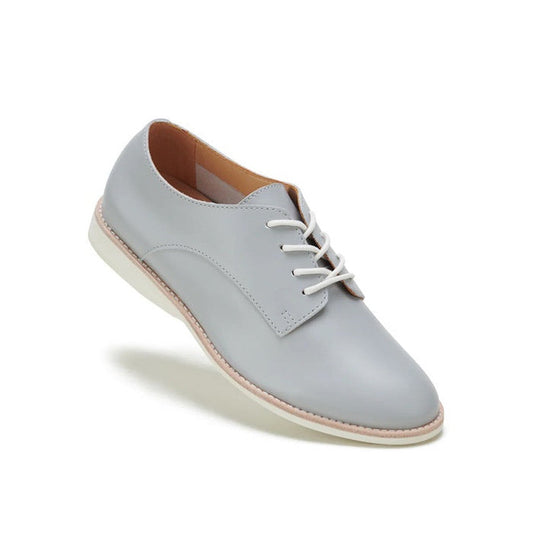 The Rollie Womens Derby Super Soft Stone Leather Shoe features premium light gray leather, white laces, a beige interior, and a white sole for sneaker-like comfort, shown against a plain white background.