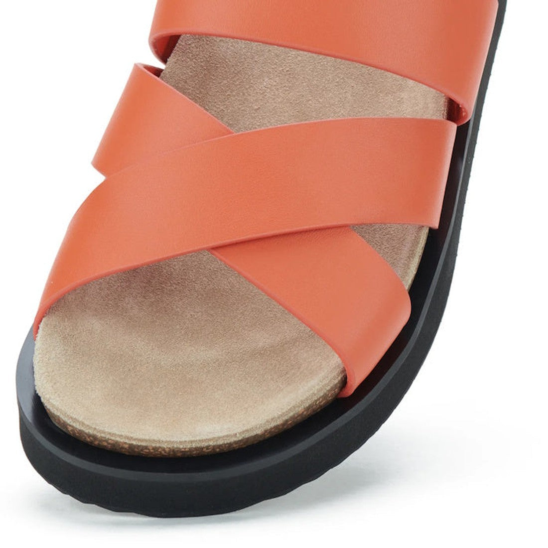Close-up of the Rollie Womens Rhodes Cross Slide in Tangerine Leather, featuring wide crisscross orange premium leather straps, a beige footbed, thick black sole with arch support, and an open-toe design shown at an angle., 9781760767389, 9781760767396, 9