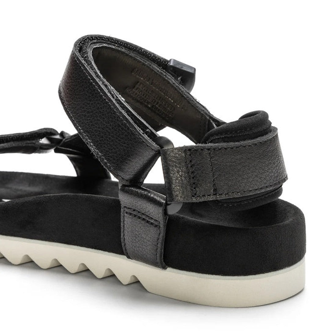 Close-up of the Rollie Womens Sandal Tooth Wedge Black, featuring adjustable sheep leather straps, a cushioned black footbed, and a white EVA sawtooth outsole with Velcro ankle and heel closures for a secure fit., 9339554310381, 9339554310398, 93395543104