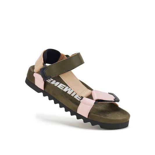 The Rollie Womens Sandal Tooth Wedge Blush Camo features a jagged black EVA outsole, olive green adjustable sheep leather ankle strap, pink and beige toe straps, and partially visible white text on the dark green footbed.