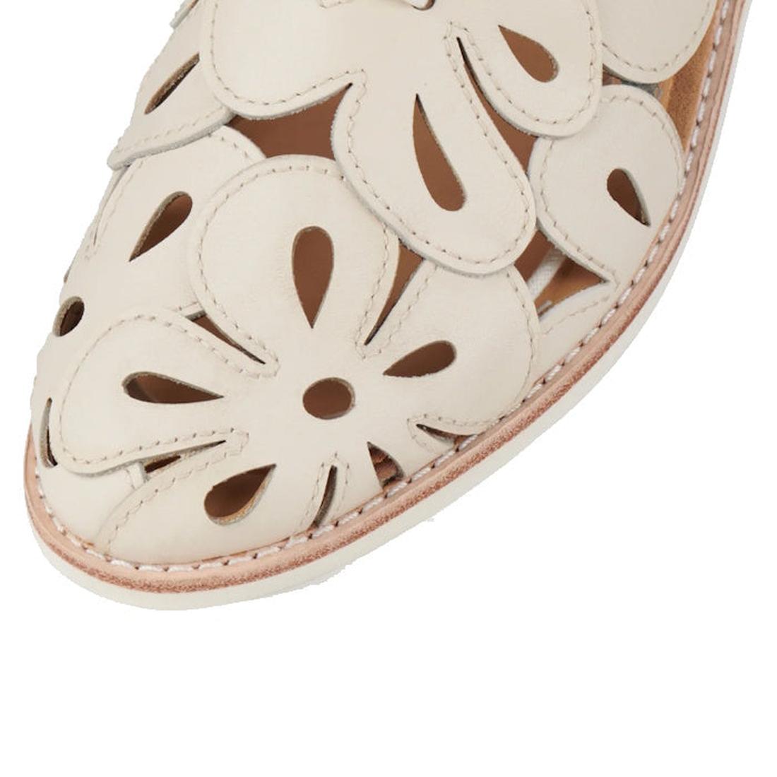 Close-up of a Rollie Derby Sidecut Applique Bone Womens Leather Shoe, an off-white Derby featuring large, floral-shaped cutouts.