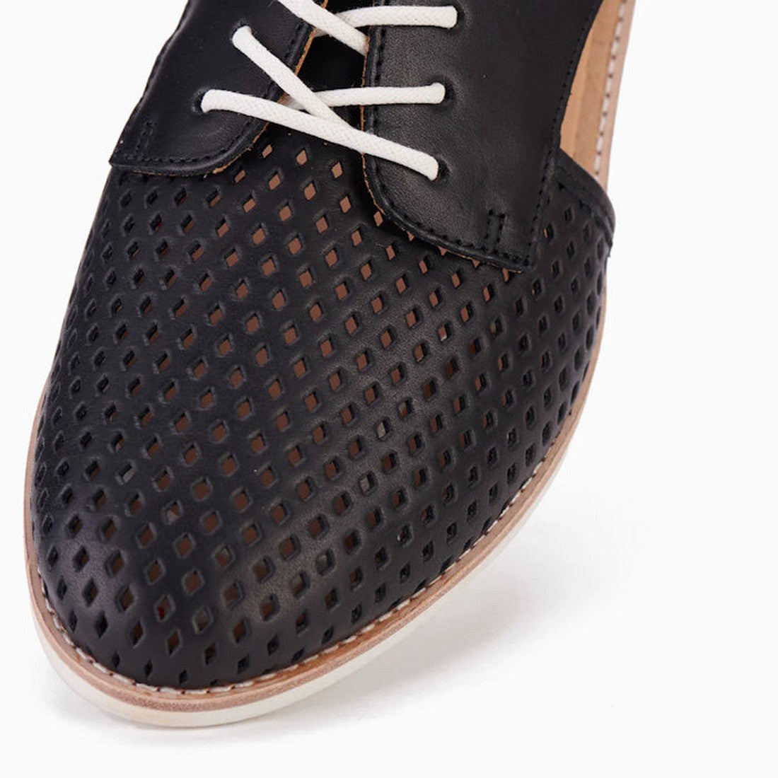 Close-up of the Rollie Womens Sidecut Punch Black Leather Shoe featuring a perforated diamond toe pattern and white laces, highlighting its breathable design against a white background., 9339554249179, 9339554249186, 9339554249193, 9339554249209, 93395542