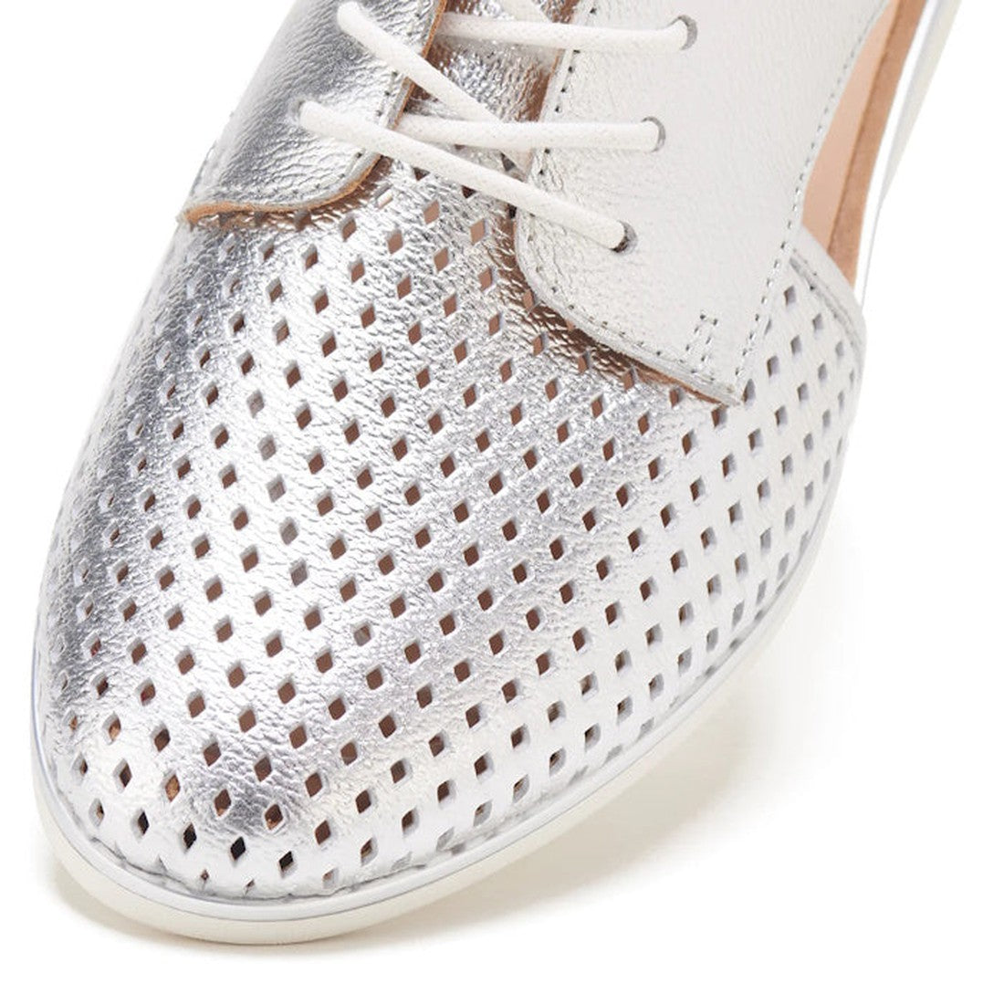 Close-up of the Rollie Womens Sidecut Punch Silver Metallic Leather Shoe, with a metallic silver perforated toe, white leather upper, white laces, beige lining, and an anti-slip rubber outsole for stability., 9339554231341, 9339554231358, 9339554231365, 9