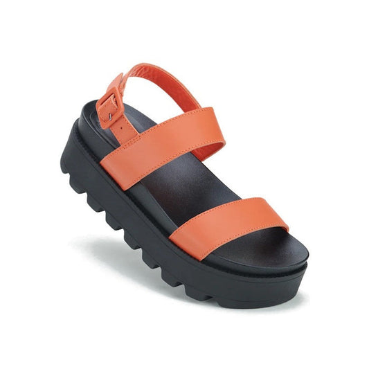 The Rollie Womens Zeze Wedge Strap Sandal in Tangerine/Black Leather features a chunky black sole, wide orange foot straps, an orange ankle strap with buckle, and a rugged tread for modern comfort and everyday wear.
