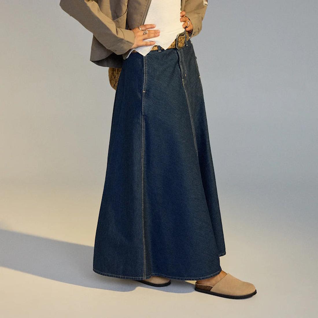 Person wearing a long denim skirt with  a pair or Rollie Mills Mule in Camel suede on feet on a neutral background.,
9781760789114,
9781760789121,
9781760789138,
9781760789145,
97817760789152,, 9781760789114, 9781760789121, 9781760789138, 9781760789145, 9