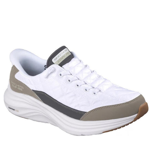 The Skechers Men's Slip-In Contour Foam Cozy Fit in white and taupe features gray/beige accents, quilting detail, a thick cushioned sole with Air-Cooled Memory Foam, beige heel/toe overlays, and a Skechers logo patch on the tongue.