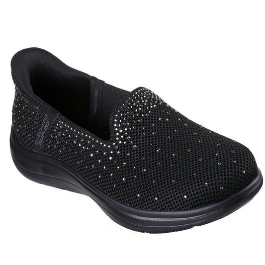 Introducing the Skechers Slip In On The Go Flex Radiant Dazzled Black—a black slip-on shoe with a low heel, adorned with small, sparkling rhinestones. This style features a rhinestone-embellished knit upper that is both stretchy and breathable, along with