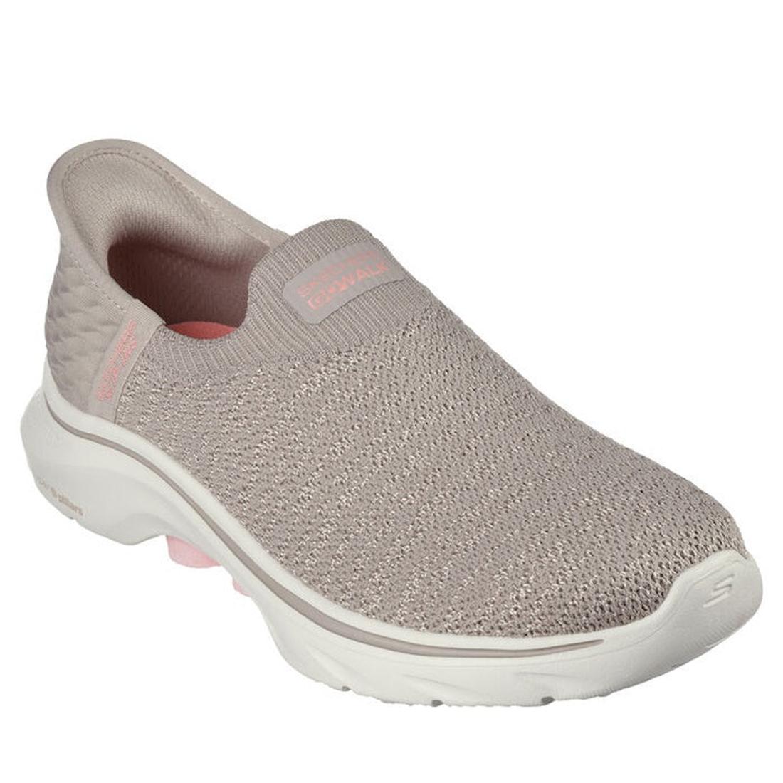 The Skechers Womens Slip In GO WALK 7 Springtime Taupe WIDE WIDTH is a light taupe slip-on sneaker with a textured knit upper, white cushioned sole, subtle pink accents, and Air-Cooled Memory Foam for comfort—ideal for casual wear.