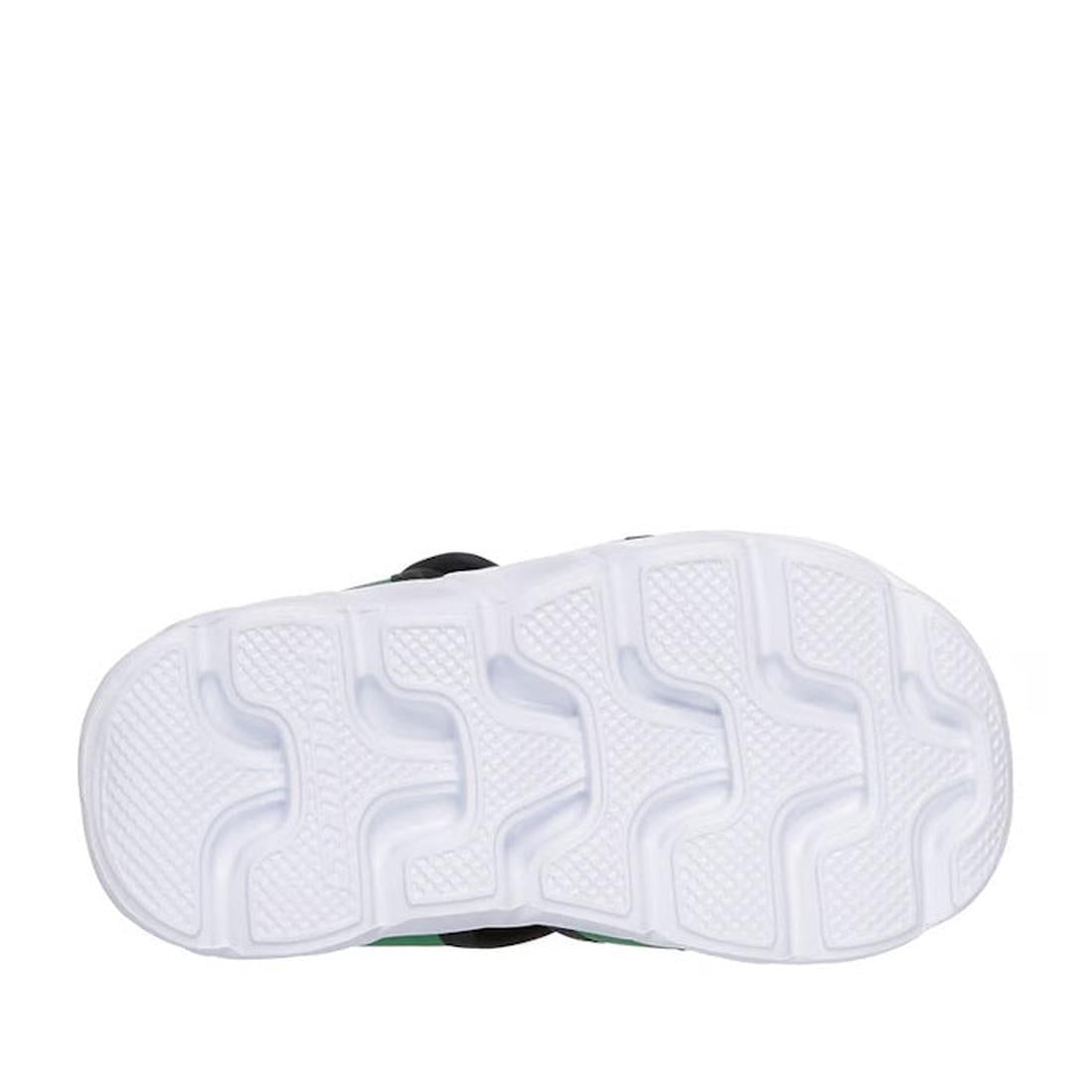 The image shows the bottom of a Skechers Toddlers Hypno Splash Green John Deere Sandal with a textured, wavy tread for grip. The sole has a faint green tint, and the background is plain white., 198739181814, 198739181821, 198739181838, 198739181845