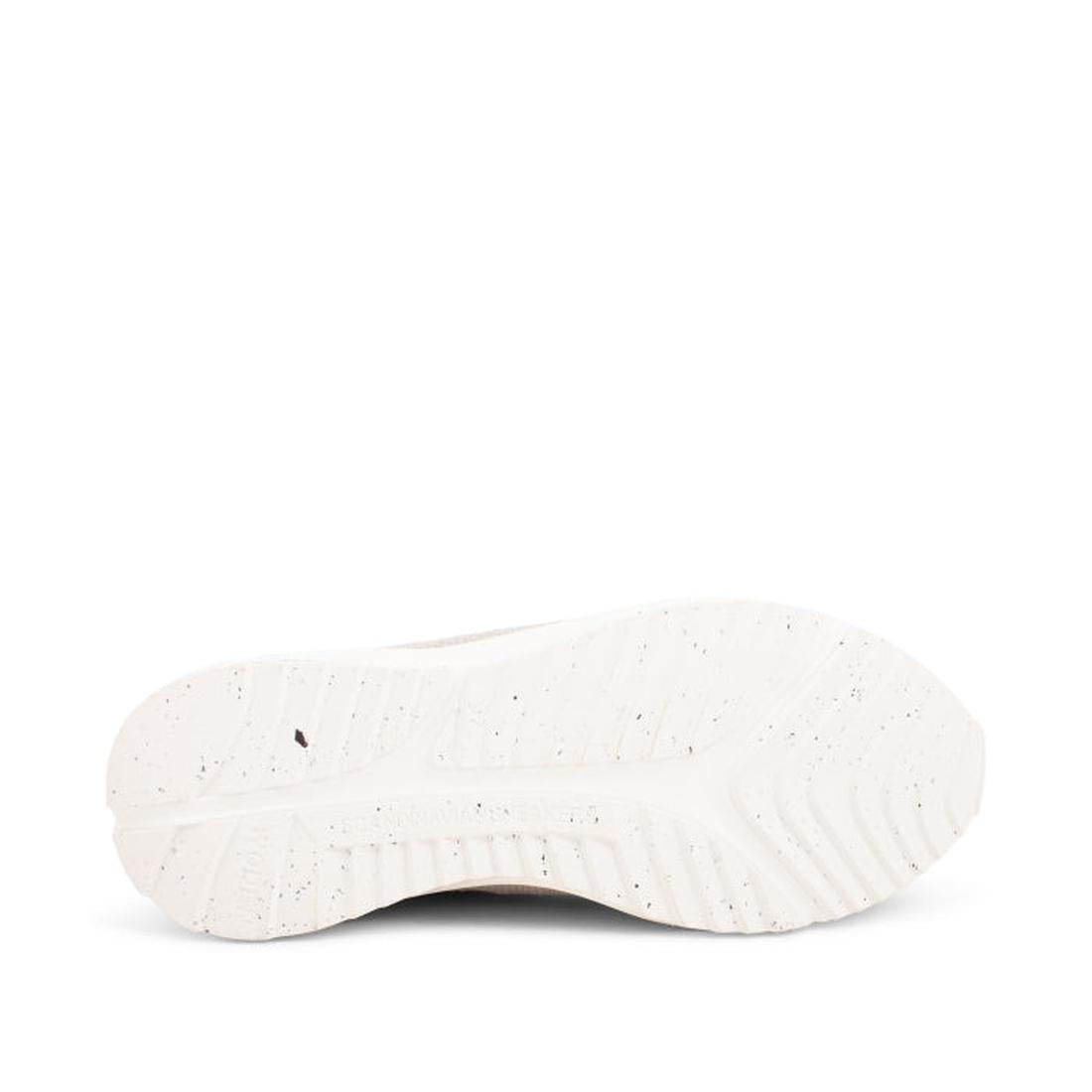 Close-up view of the white outsole of the Woden - Sophie Snake Suede - Sea Fog Grey Womens Sneaker, highlighting its textured grip patterns and subtle speckling, photographed against a plain white background., 5713326155754, 5713326155761, 5713326155778, 