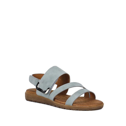 The Soultbush Flinders Denim Women’s Sandal with Back Strap is a light blue sandal featuring three straps and an open toe, complemented by a brown flat sole and a cushioned footbed for all-day comfort. An adjustable Velcro back strap ensures a secure fit.