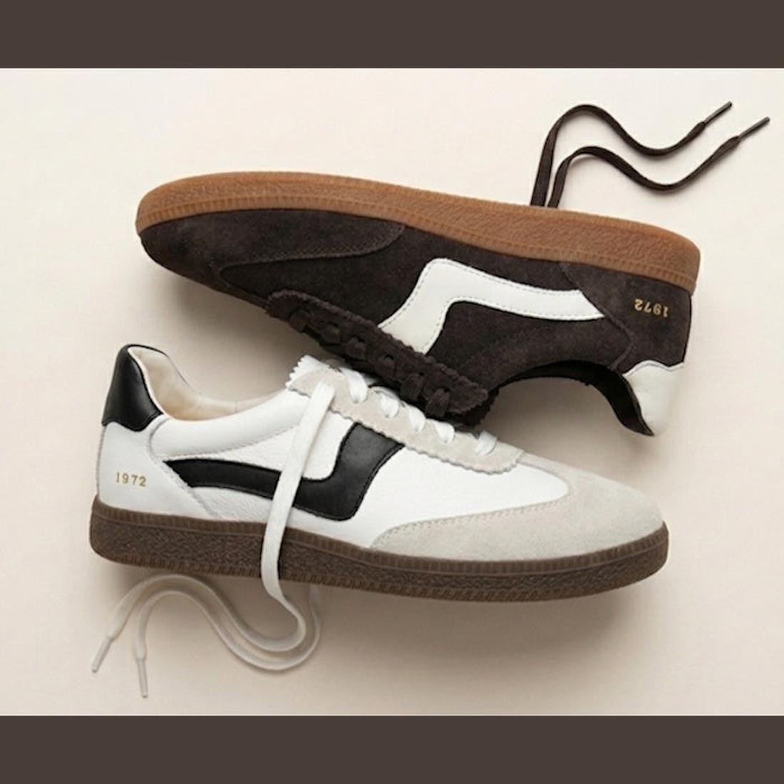 Two Gelato Staton Swan Off White and Cafe Leather Lace Women's Sneakers are displayed side by side, featuring gum soles, retro design, and "1972" in gold on the heel—one in off-white with black accents, the other in brown with white details., 52483, 52484