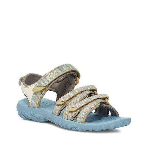 The Teva Girls Active Sandal K Tirra STACKS COCOON features a light blue rugged sole, quick-dry webbing straps in blue, yellow, and beige, Velcro closure, and open toe—ideal vegan footwear for day hikes. Displayed on a plain white background.