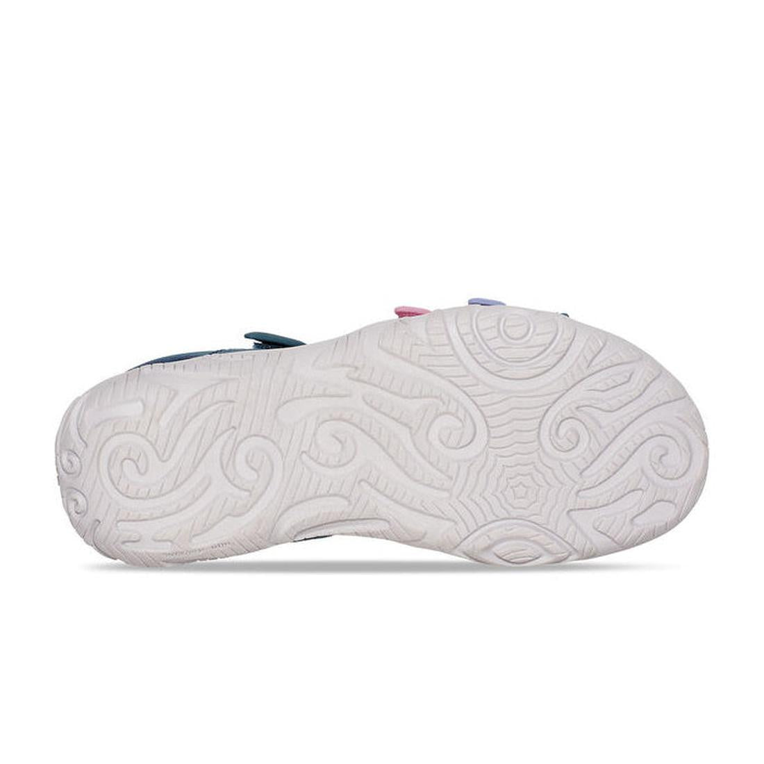 The image shows the sole of the Teva Girls Active Sandal K Tirra in Blue Coral Multi, featuring an intricate swirling white rubber tread pattern, with the sandal positioned sole-up to highlight the design., 195719341190, 195719341206, 195719341213, 195719