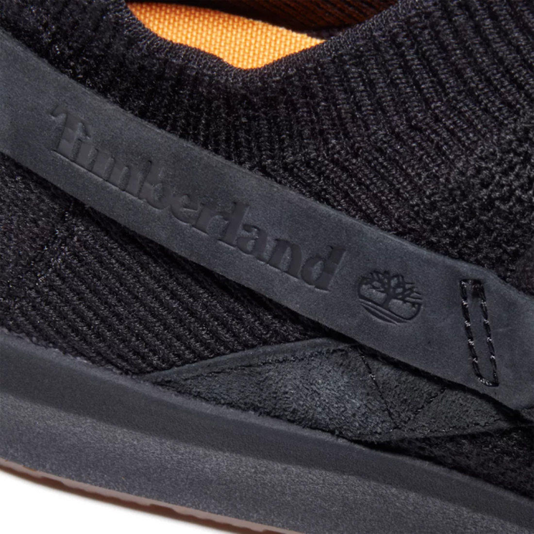 Timberland Mens TrueCloud EK+ SlipOn in black canvas—a comfy, eco-friendly slip-on with a soft sole and bright orange lining.  ksnz