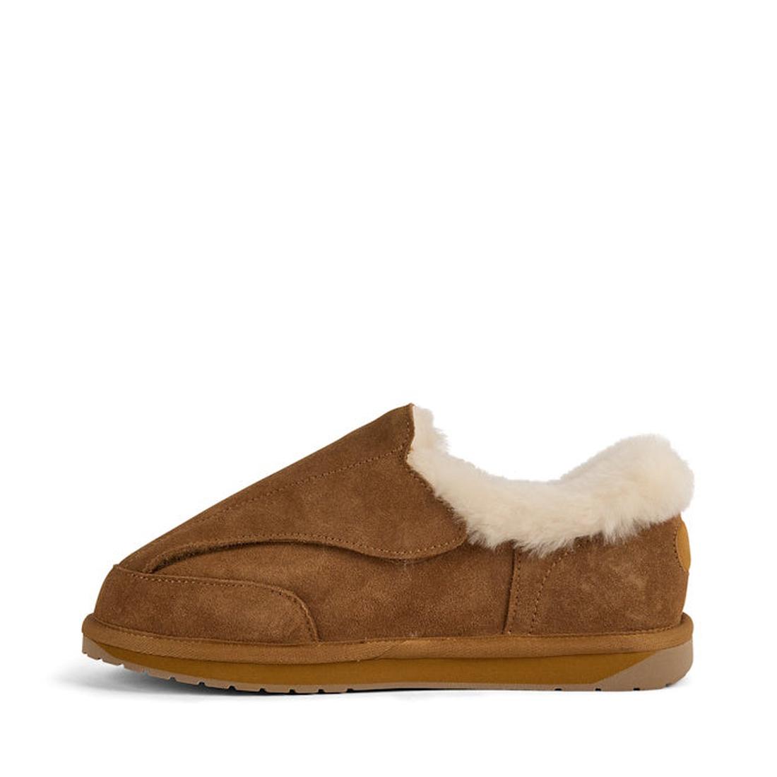 The EMU FlexiCare Wide Opening Sheepskin Slippers in Chestnut feature a brown suede upper, plush white shearling lining, and a rubber sole, shown in side profile against a plain white background., 9330071990957, 9330071990964, 9330071990971, 9330071990988