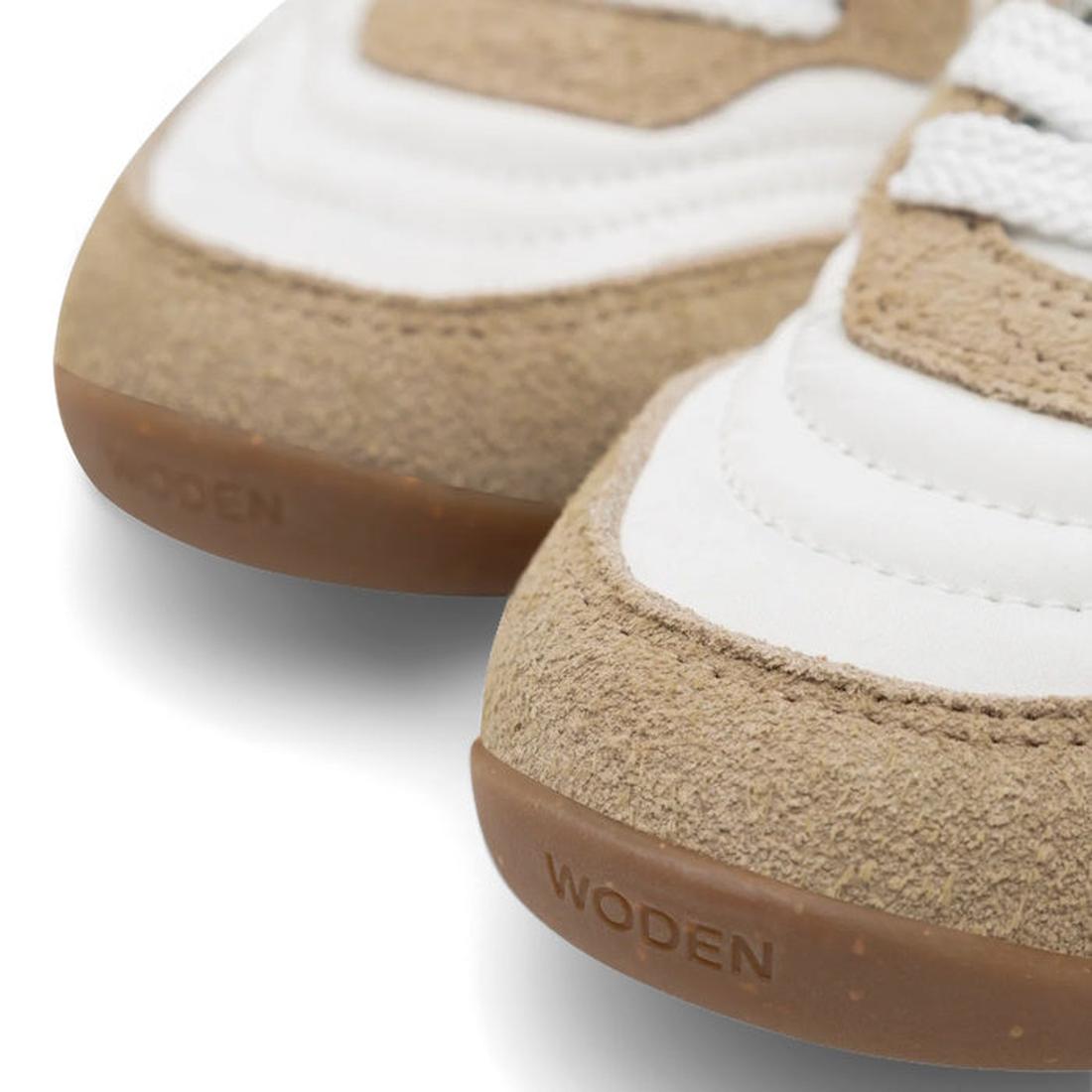 Close-up of Woden Nanna Blanc De Blance White Lace Up Sneakers with tan suede accents, white panels, white laces, and brown rubber soles embossed with "WODEN"—a lightweight, travel-friendly sneaker option., 50285, 5713326712193, 5713326712209, 57133267122