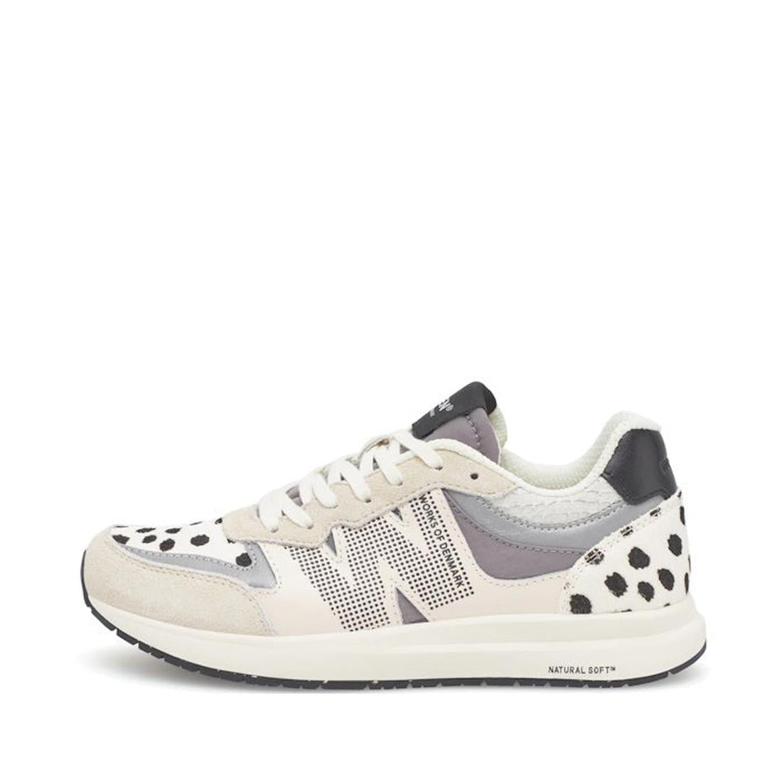 The Woden Rigmor Animal Damlation Lace Up Sneaker features white laces, beige and light gray panels, black polka dot accents, a black and white sole, a textured N logo, and high-quality LWG certified leather.