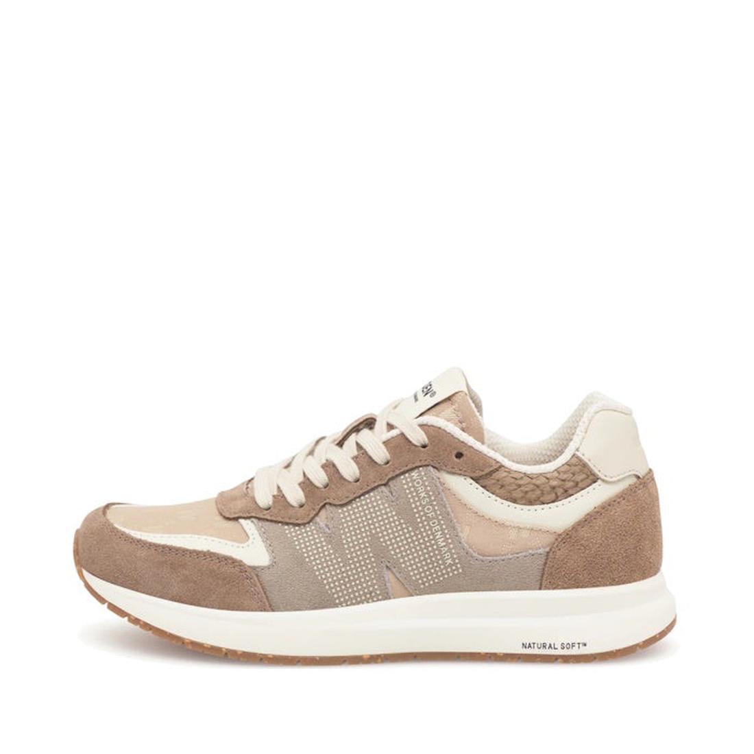 The Woden Rigmor Heritage Coffee Cream Lace Up Sneaker features LWG certified suede and mesh in beige and brown, a lace-up closure, perforated side logo, white midsole with NATURAL SOFT text, and a textured pattern.