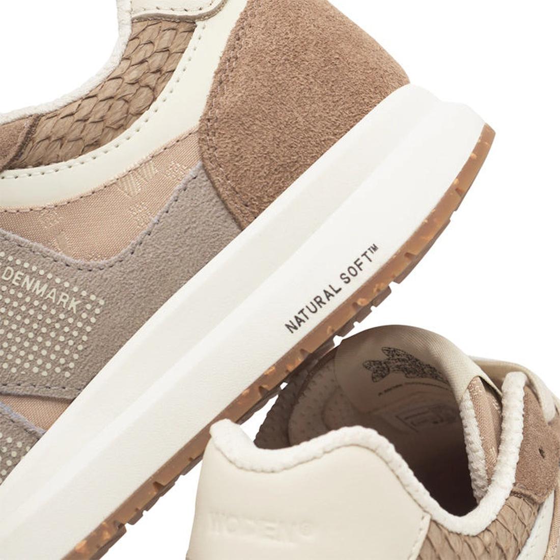 Close-up of Woden Rigmor Heritage Coffee Cream Lace Up Sneakers with beige and tan textured details, LWG certified suede, white soles, "NATURAL SOFT™" on the midsole, DENMARK text, and a patterned heel lining., 50259, 5713326695113, 5713326695120, 5713326