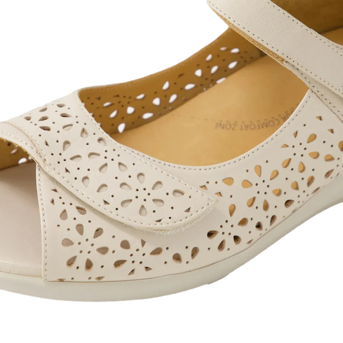 Close-up of the Ziera Daffodil W Women's Almond Off White Leather Sandal featuring floral cutouts, a hook-and-loop strap, and cushioned insole—ideal comfortable summer shoes with gentle arch support., 49093, 49094, 9351017754167, 9351017754174, 9351017754