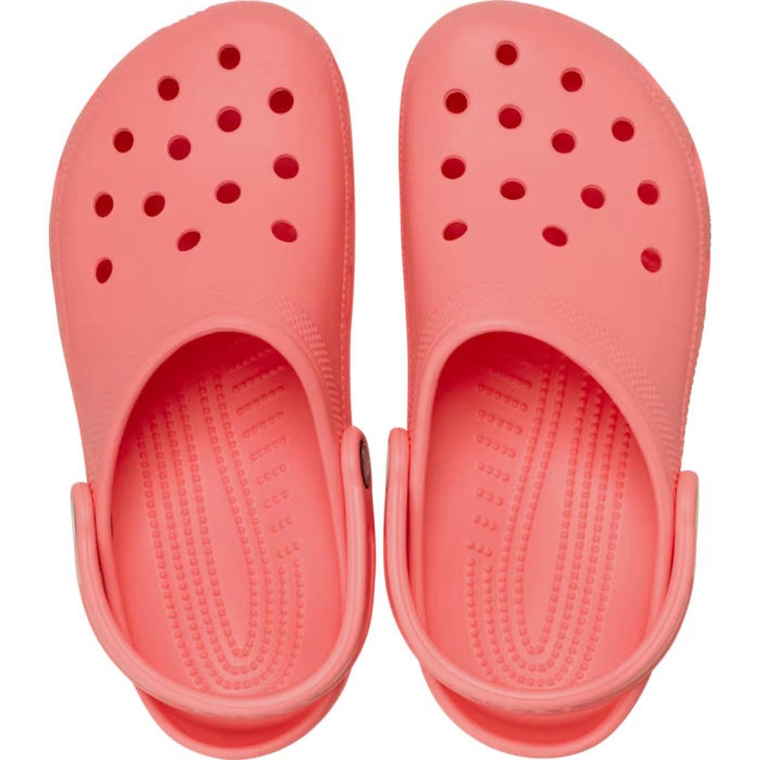 A pair of Crocs - Classic Clog Adults Guava Pink Orange with ventilation holes and adjustable heel straps, seen from above, offering signature Crocs Comfort., 49797, 49798, 49799, 49800, 49801, 49802, 49803, 49804, 49805, 49797, 198445380419, 198445380426