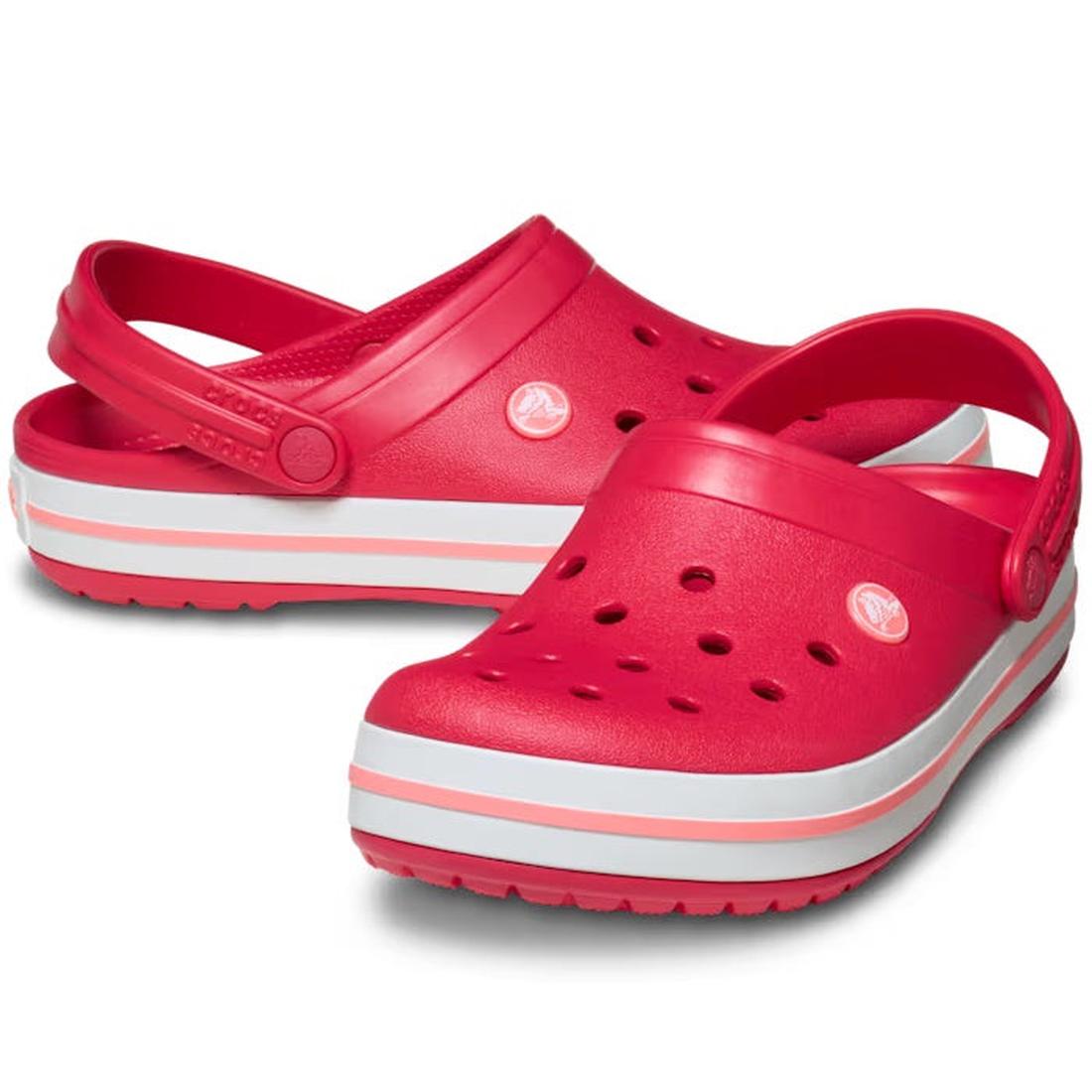 A pair of Crocs Crocband Clog Digital Raspberry Mens Womens, featuring bright pink color, white and pink striped soles, ventilation holes on top, and adjustable heel straps.