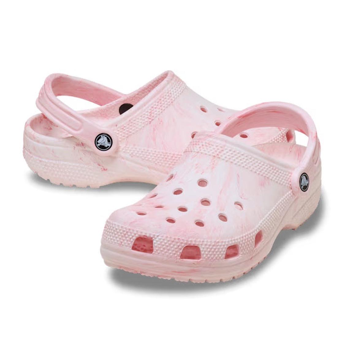 The Crocs - Classic Watercolour Marbled Clog Guava Swirl features soft Croslite foam, light pink and white marbled patterns, ventilation holes, and adjustable heel straps, shown on a white background.