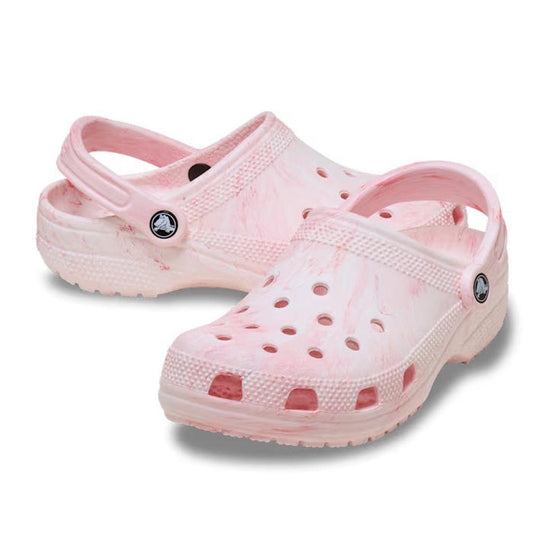 The Crocs - Classic Watercolour Marbled Clog Guava Swirl features soft Croslite foam, light pink and white marbled patterns, ventilation holes, and adjustable heel straps, shown on a white background.