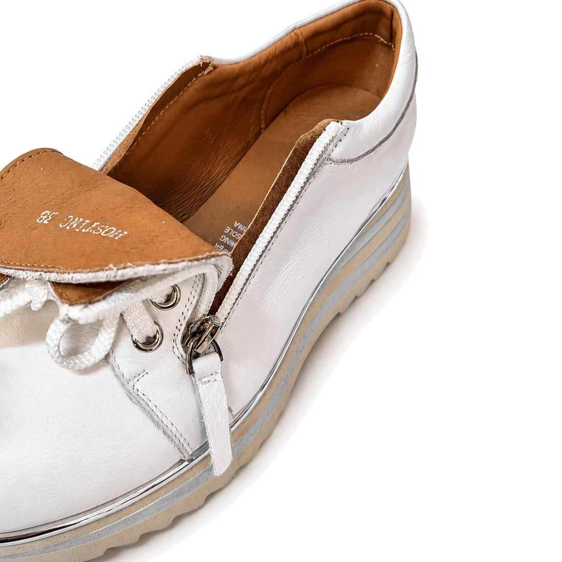 The Alfie & Evie Hosting Women's Leather Shoe in White/Silver features a platform sole, tan interior, side zipper, and top laces. Shown from an angled overhead view against a white background, this shoe blends style and comfort., 43583, 43584, 43585, 4358