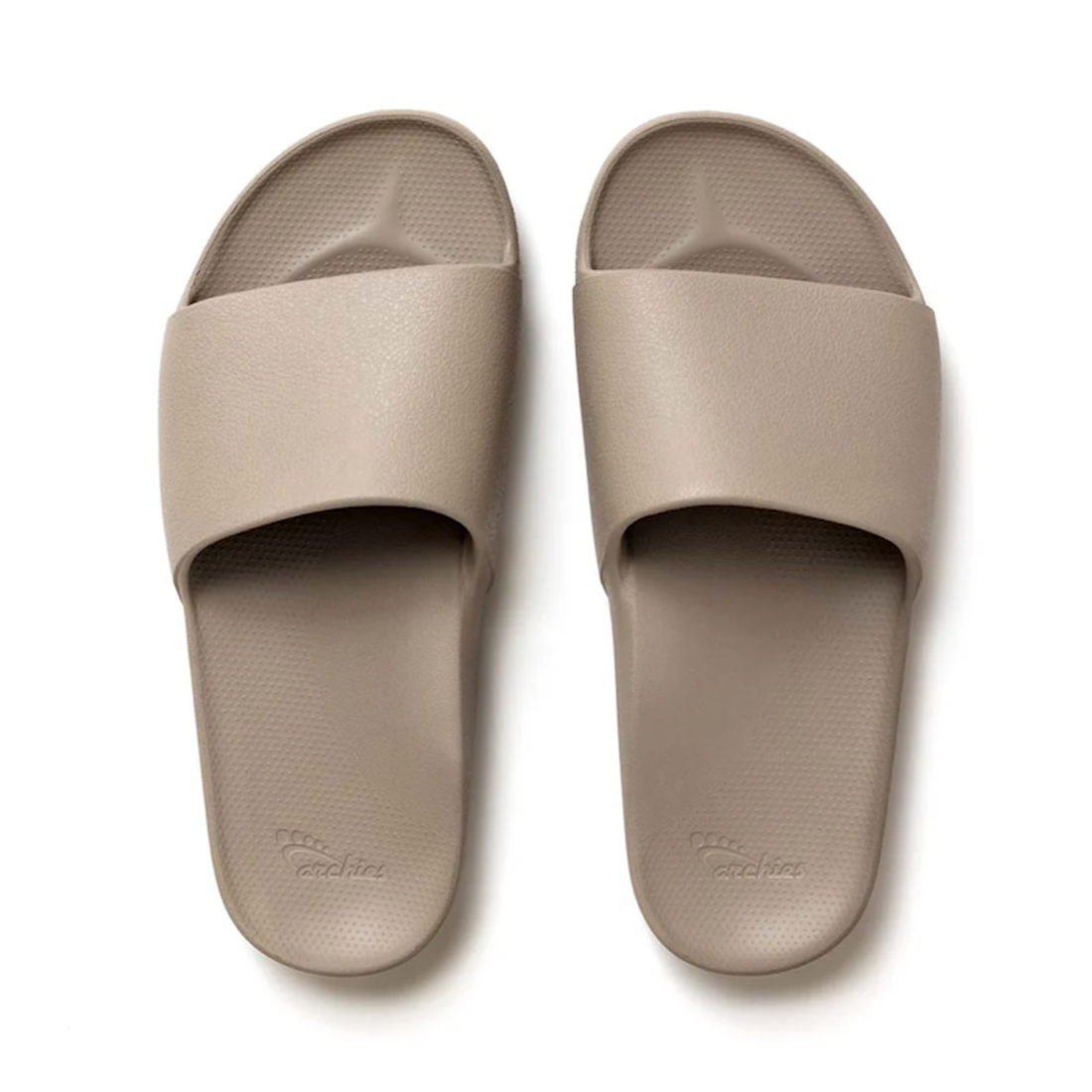 Archies Footwear’s Archies Arch Support Slide Taupe sandals, with comfy wide straps, grippy textured soles, and easy slip-on design.  ksnz