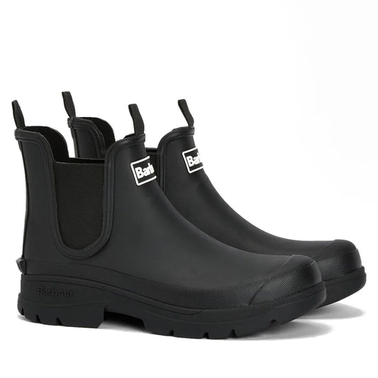 The Barbour Nimbus Black Chelsea Wellingtons Men’s Rainboot features a waterproof ankle boot design with elastic side panels, pull tabs, and thick ridged soles, displayed against a white background.