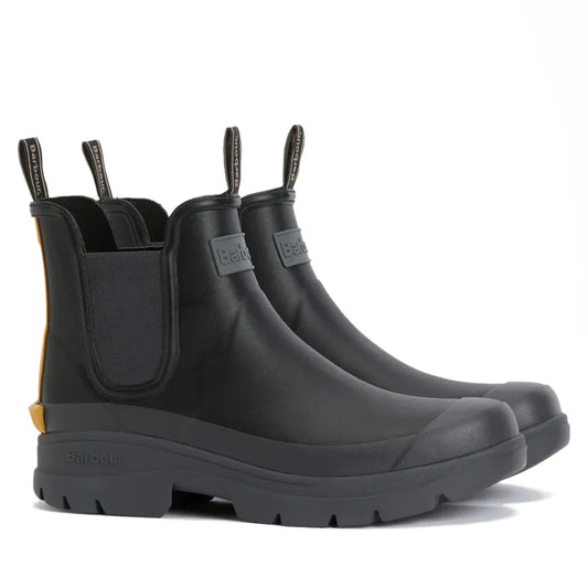 The Barbour Nimbus Black/Ochre Chelsea Wellingtons Mens Rainboot features a Chelsea boot style with black uppers, rugged soles, elastic side panels, pull tabs, and an ochre yellow heel accent, shown against a white background.