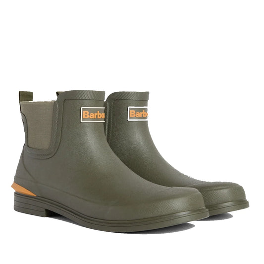 A pair of Barbour Abbeyfield Packable Ankle Wellingtons in olive, these lightweight wellies feature elastic side panels, a back pull tab, and Barbour logos on the front.