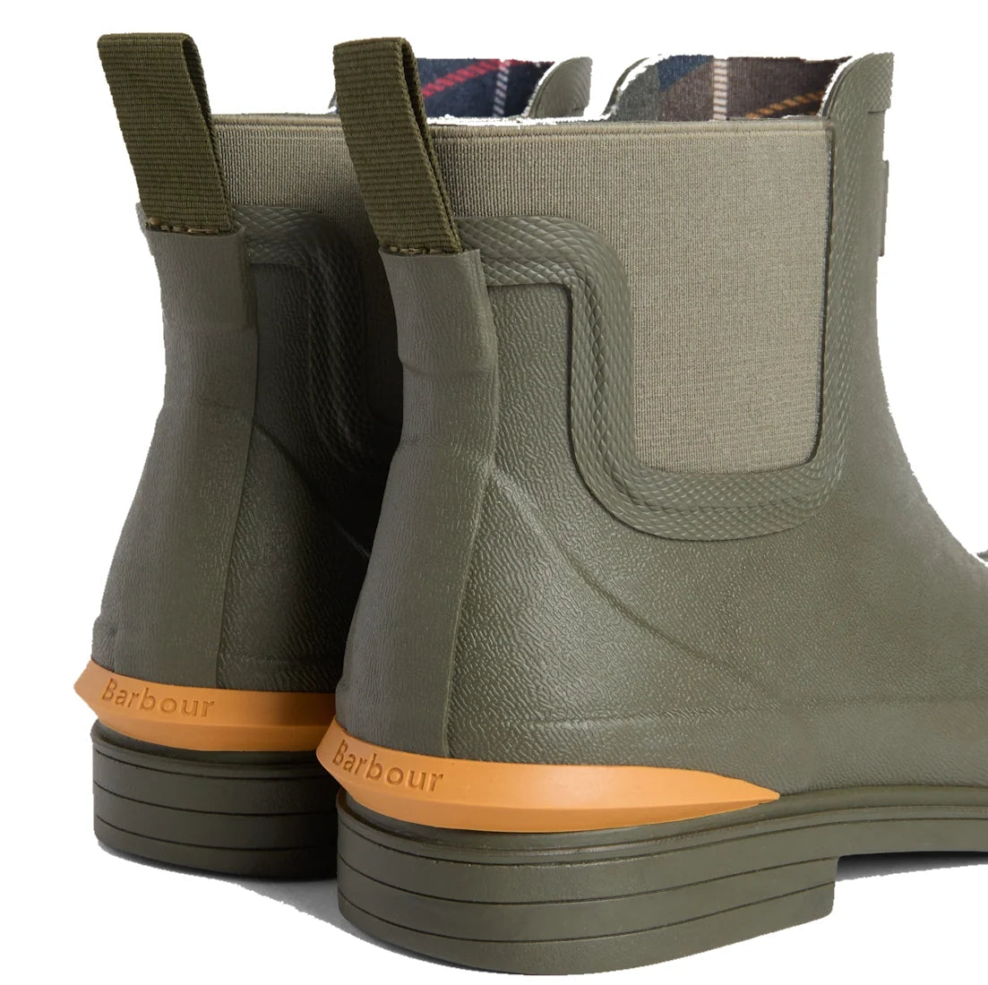 A close-up of the back of two Barbour Abbeyfield Packable Ankle Wellingtons Olive showcases their olive green color, orange soles, pull tabs, fabric sides, and Barbour branding above the heels. These lightweight wellingtons are perfect for on-the-go adven