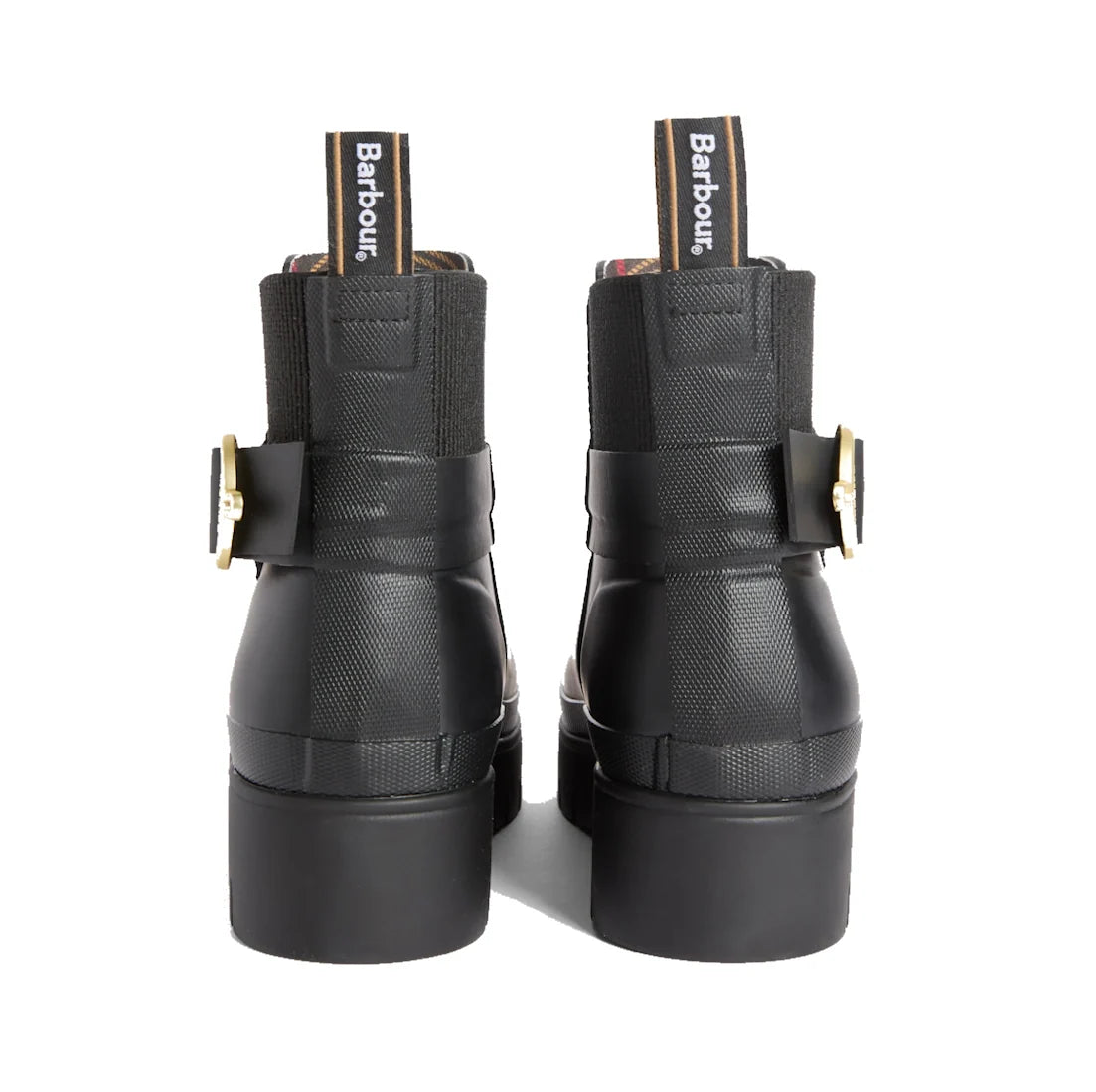 Back view of the Barbour Hepburn Platform Ankle Wellingtons Boots in black, featuring chunky heels, gold side buckles, elastic panels, and Barbour-branded pull tabs. These women’s ankle boots showcase a textured finish on the upper for a stylish update to